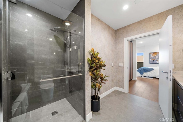 bathroom featuring hardwood / wood-style flooring, vanity, and a shower with door