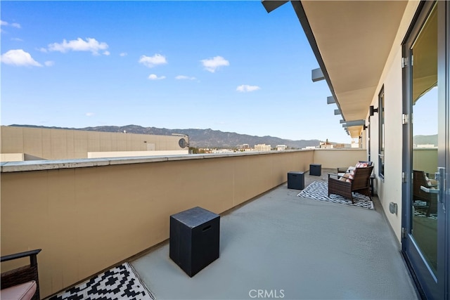 view of patio / terrace with a mountain view and a balcony