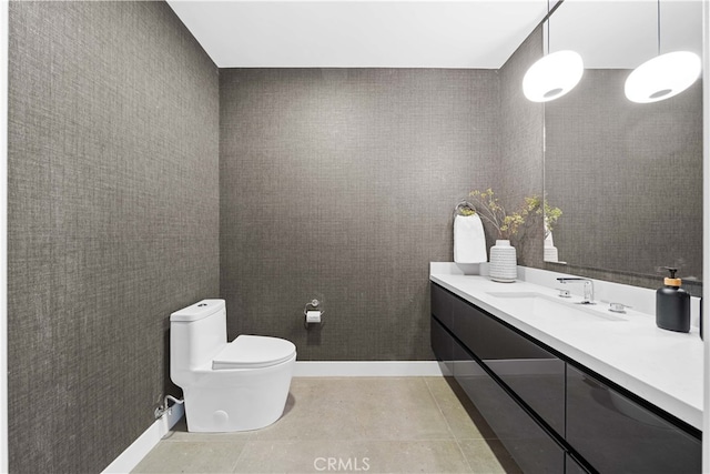 bathroom with tile patterned flooring, vanity, and toilet