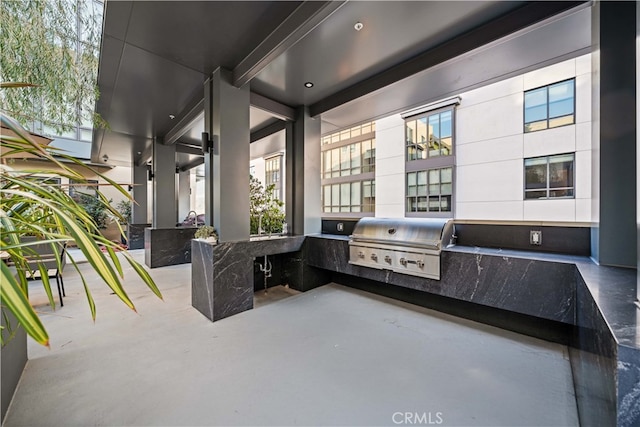 view of patio / terrace featuring an outdoor kitchen and a grill