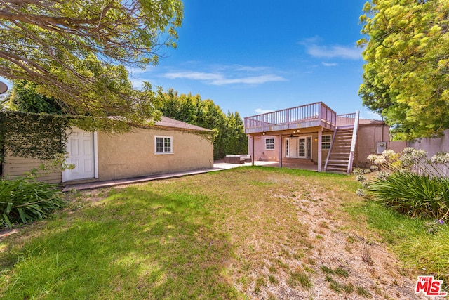 view of yard featuring a patio area and a wooden deck