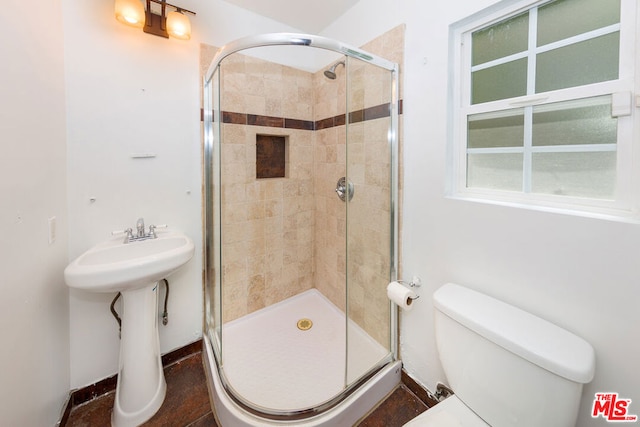 bathroom featuring sink, toilet, and walk in shower