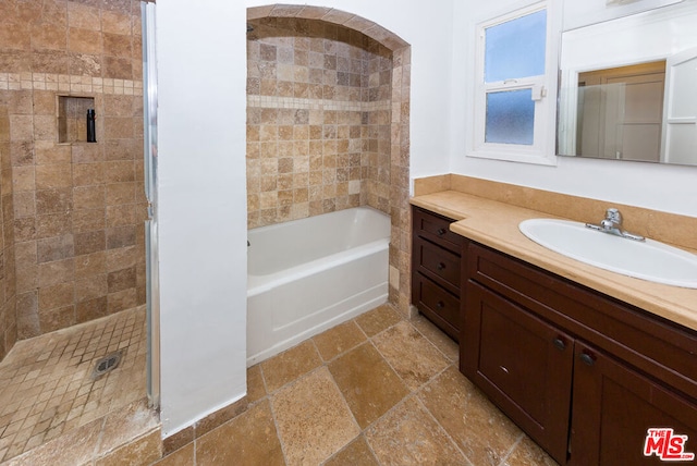 bathroom with vanity and independent shower and bath