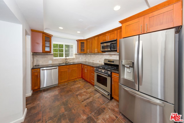 kitchen with decorative backsplash, sink, and appliances with stainless steel finishes