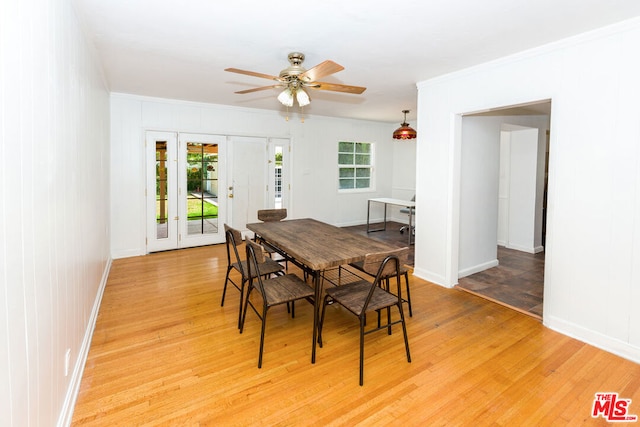 dining space with ceiling fan, french doors, ornamental molding, and hardwood / wood-style flooring