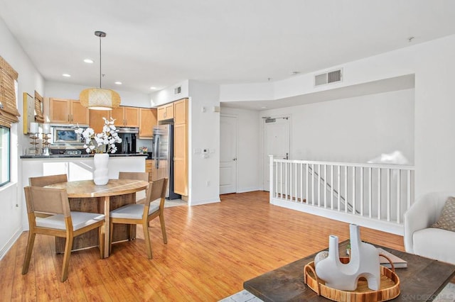 dining area with light hardwood / wood-style flooring