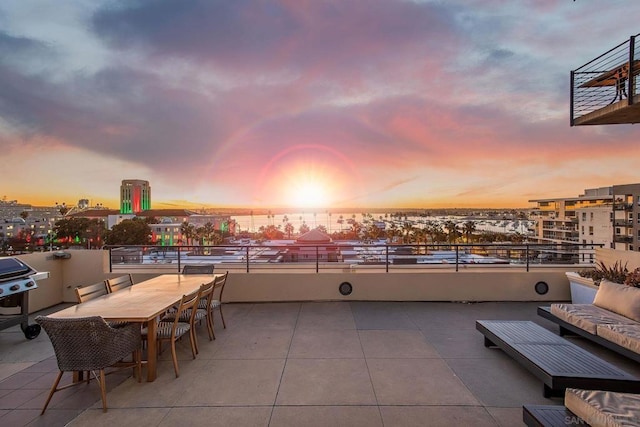 patio terrace at dusk with a grill