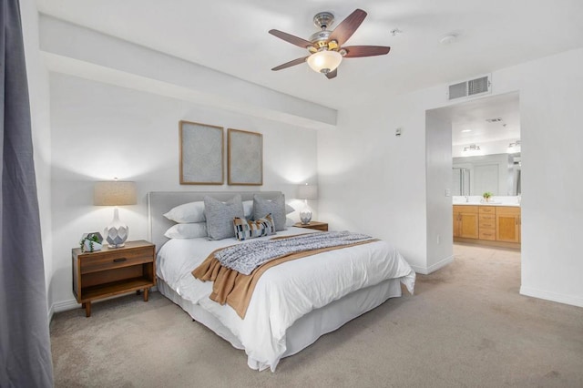 carpeted bedroom with ceiling fan and connected bathroom