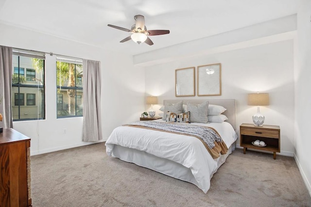 bedroom featuring ceiling fan and light carpet