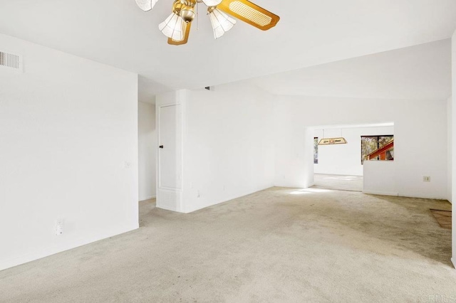 empty room featuring carpet flooring, ceiling fan, and lofted ceiling