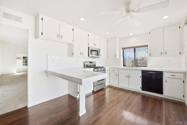 kitchen featuring white cabinets, stainless steel appliances, dark hardwood / wood-style floors, and sink