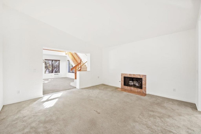 unfurnished living room featuring carpet and lofted ceiling