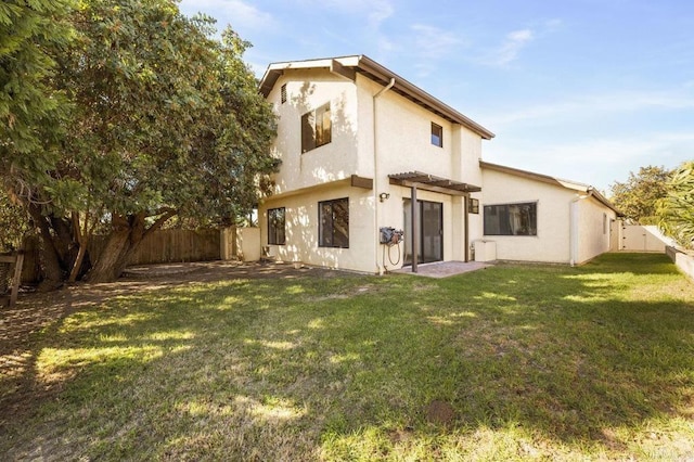 rear view of property with a lawn