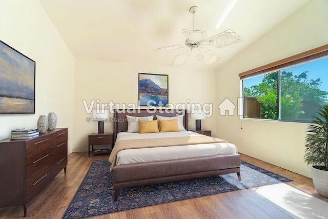 bedroom with dark hardwood / wood-style flooring, ceiling fan, and lofted ceiling