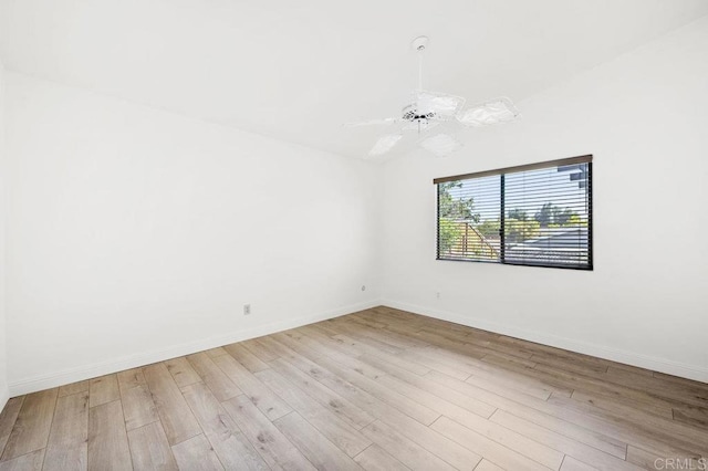 empty room with ceiling fan and light hardwood / wood-style flooring