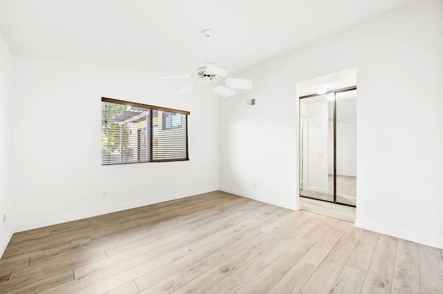 spare room with light hardwood / wood-style flooring and ceiling fan