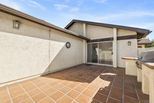 view of patio with a grill and an outdoor kitchen