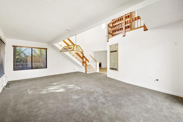 unfurnished living room featuring dark colored carpet, a textured ceiling, and vaulted ceiling