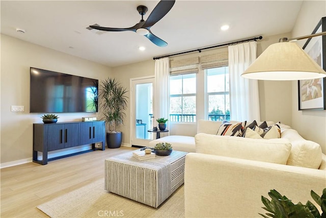 living room with ceiling fan and hardwood / wood-style flooring