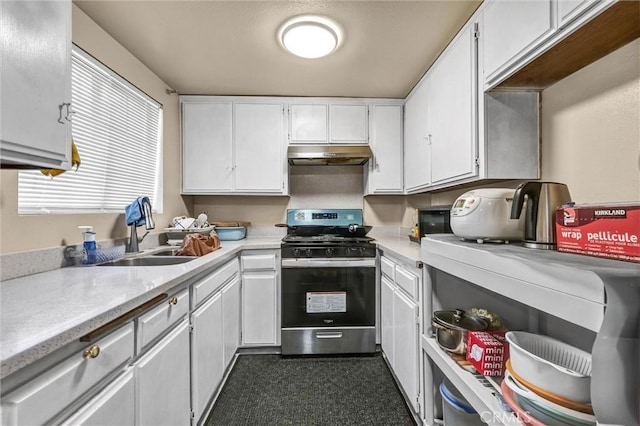 kitchen featuring white cabinetry, sink, and gas range