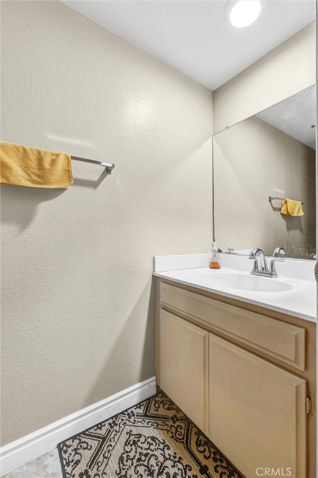 bathroom featuring tile patterned flooring and vanity