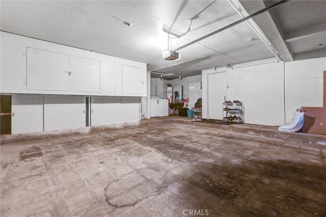 garage featuring washing machine and dryer and a garage door opener