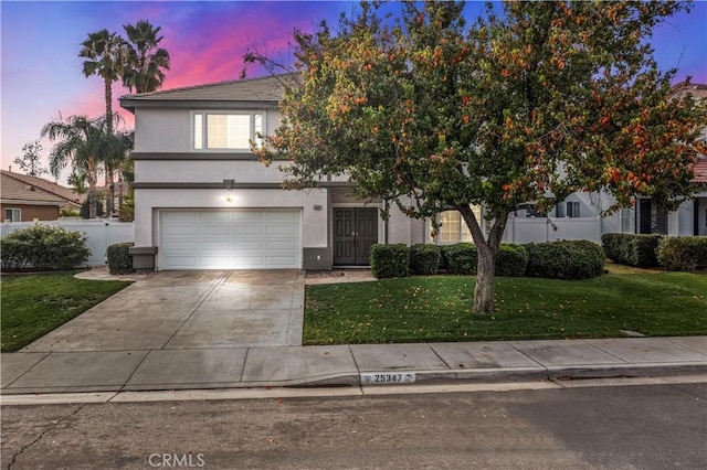 obstructed view of property with a lawn and a garage