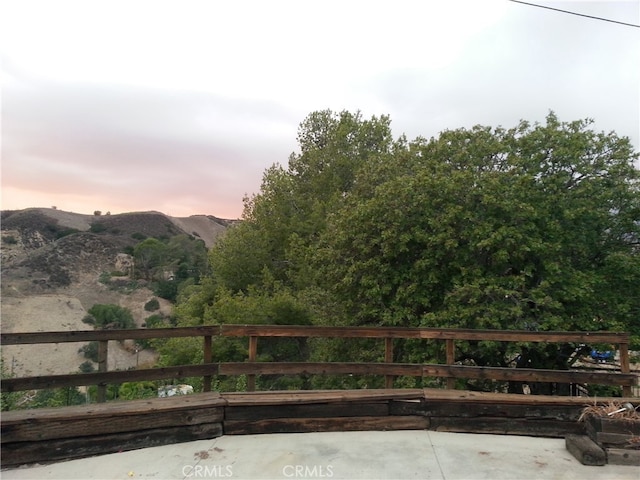 gate at dusk featuring a mountain view