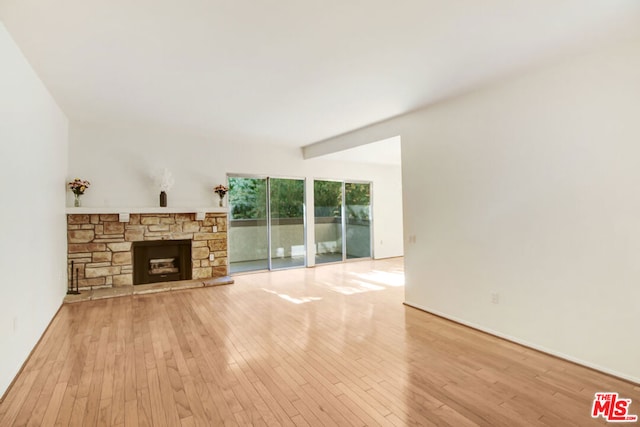 unfurnished living room featuring a fireplace and light hardwood / wood-style flooring