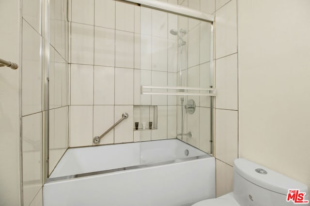 bathroom featuring toilet and enclosed tub / shower combo