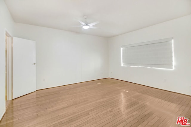 spare room featuring light hardwood / wood-style flooring and ceiling fan