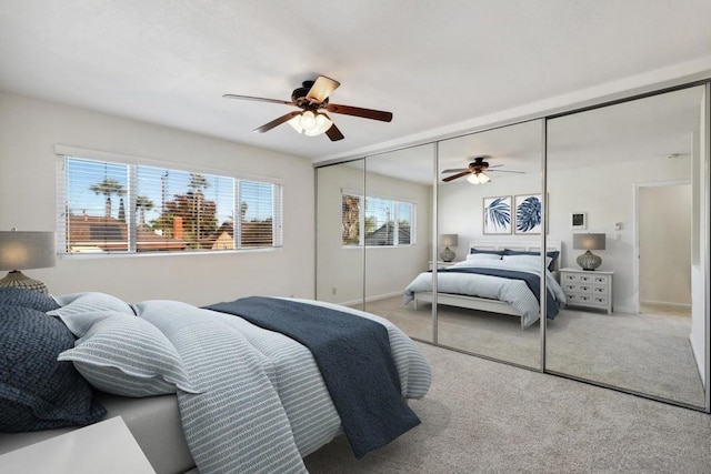 carpeted bedroom featuring a closet and ceiling fan