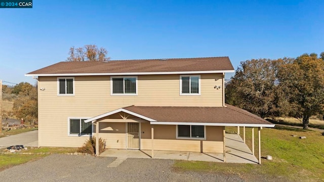 view of front of home with a patio and a front yard