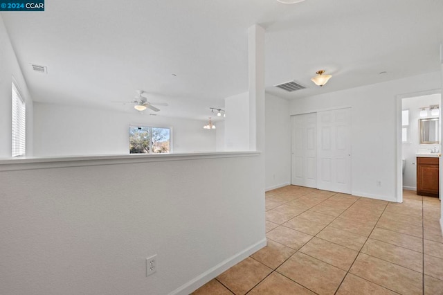 hall featuring light tile patterned floors