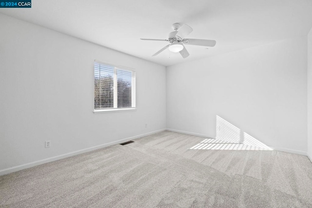 unfurnished room featuring light carpet and ceiling fan