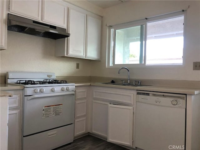 kitchen with sink, white cabinets, a healthy amount of sunlight, and white appliances