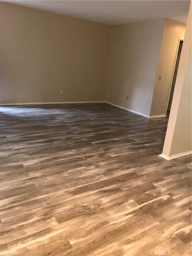 spare room featuring dark wood-type flooring