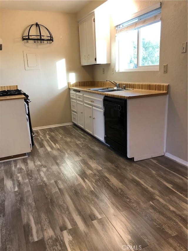 kitchen featuring white stove, sink, dark hardwood / wood-style floors, black dishwasher, and white cabinetry