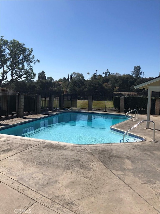 view of swimming pool with a patio