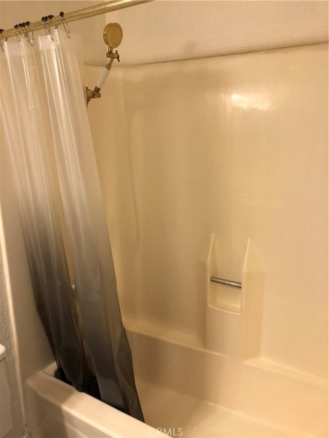 bathroom with shower / bath combination with curtain