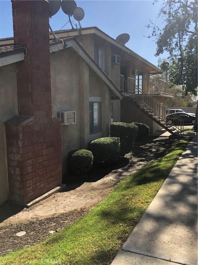 view of home's exterior with a wall mounted air conditioner