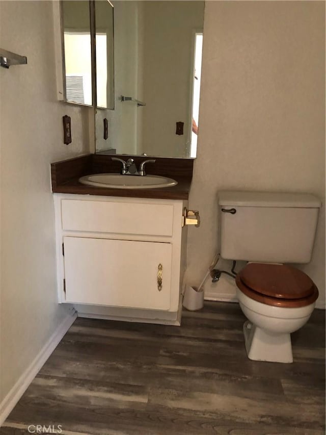 bathroom featuring hardwood / wood-style floors, vanity, and toilet