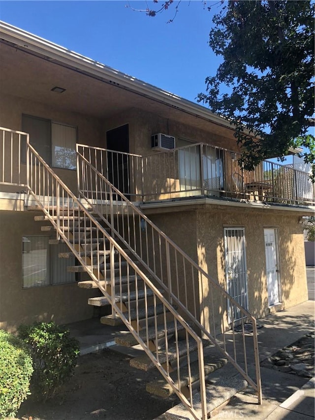 exterior space featuring an AC wall unit