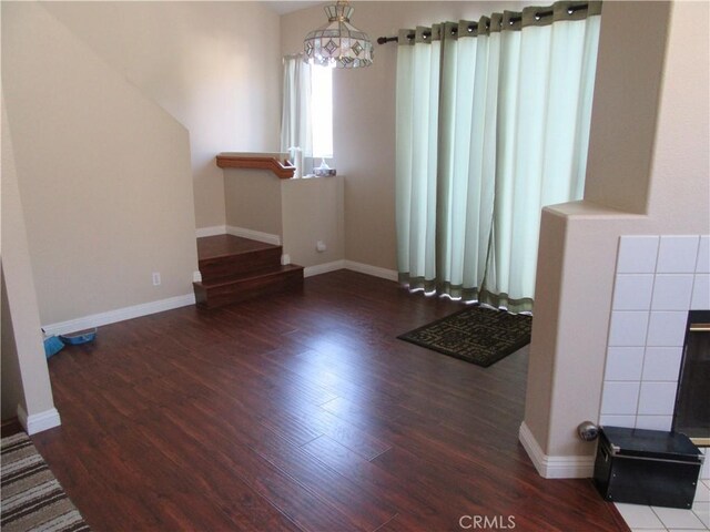 unfurnished living room featuring dark hardwood / wood-style floors