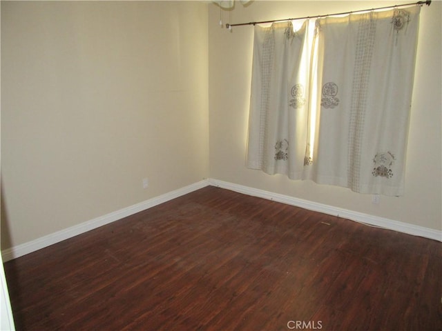 spare room with dark wood-type flooring