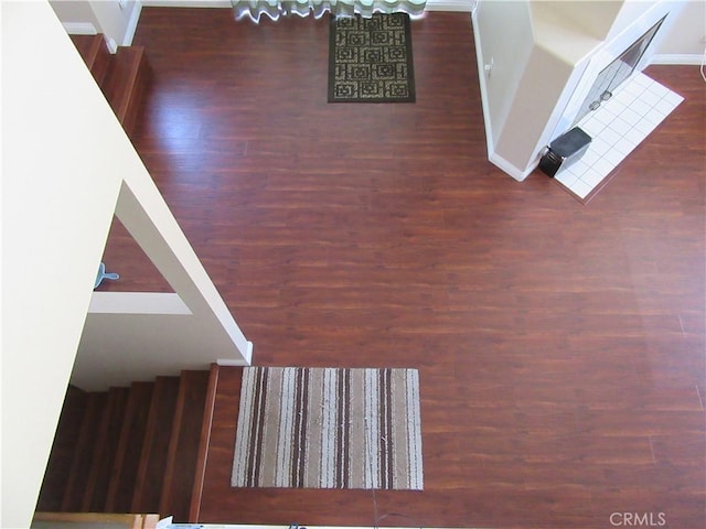 staircase with hardwood / wood-style flooring