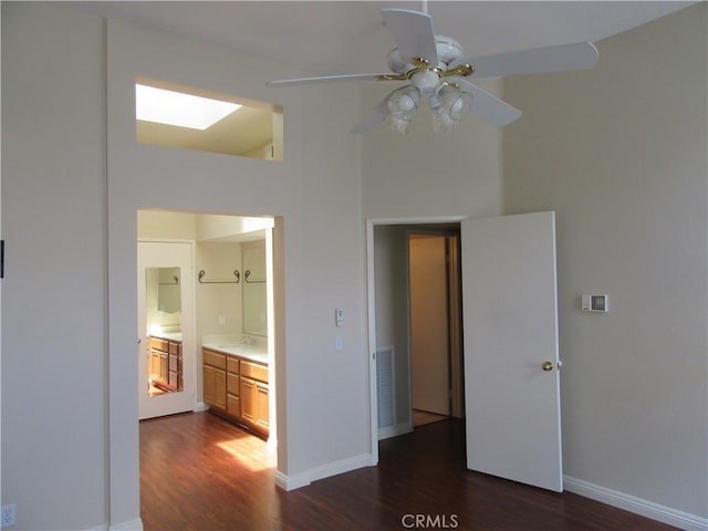 interior space featuring connected bathroom, ceiling fan, sink, and dark hardwood / wood-style floors