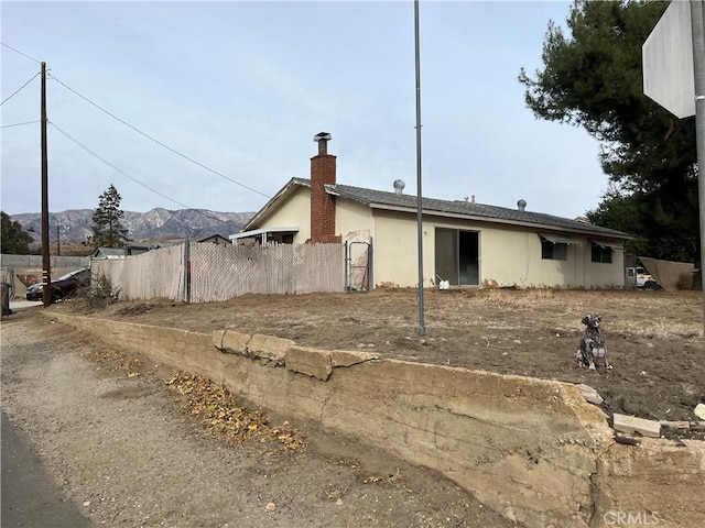 rear view of property featuring a mountain view