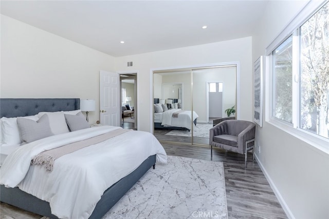 bedroom with a closet and hardwood / wood-style flooring