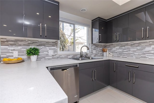 kitchen featuring backsplash, dishwasher, light tile patterned floors, and sink